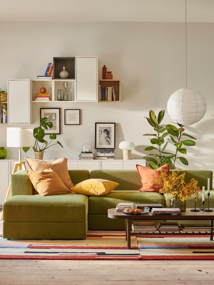 a living room filled with lots of furniture and decor on top of a hard wood floor