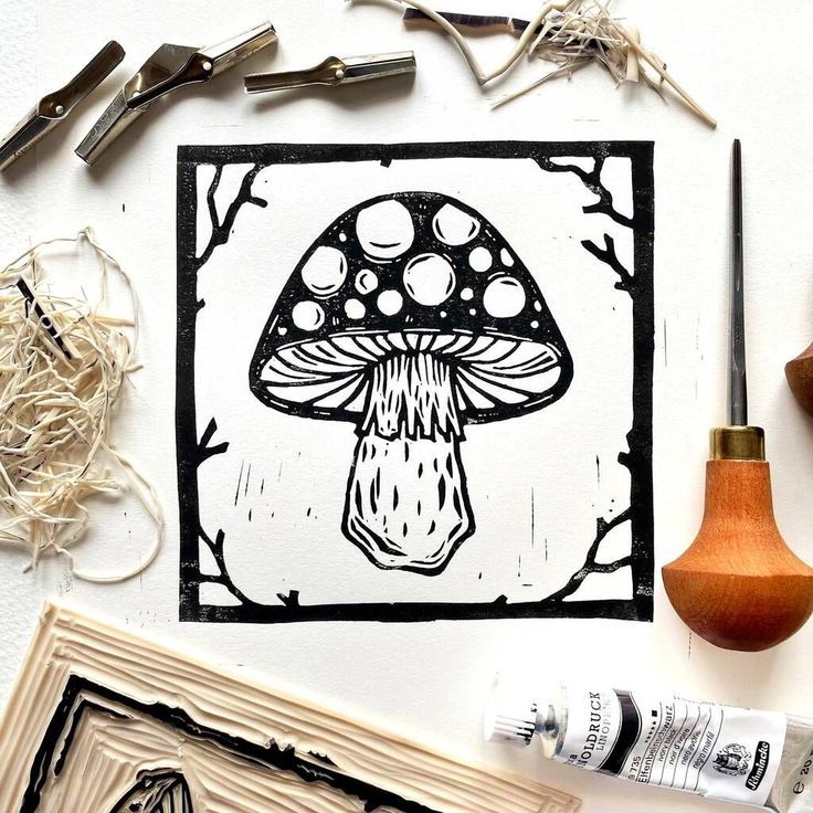 an image of a mushroom in the middle of some art work with scissors and glue