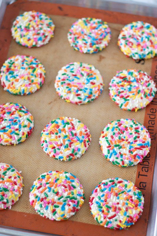 sprinkle covered cookies on a cookie sheet ready to be baked in the oven