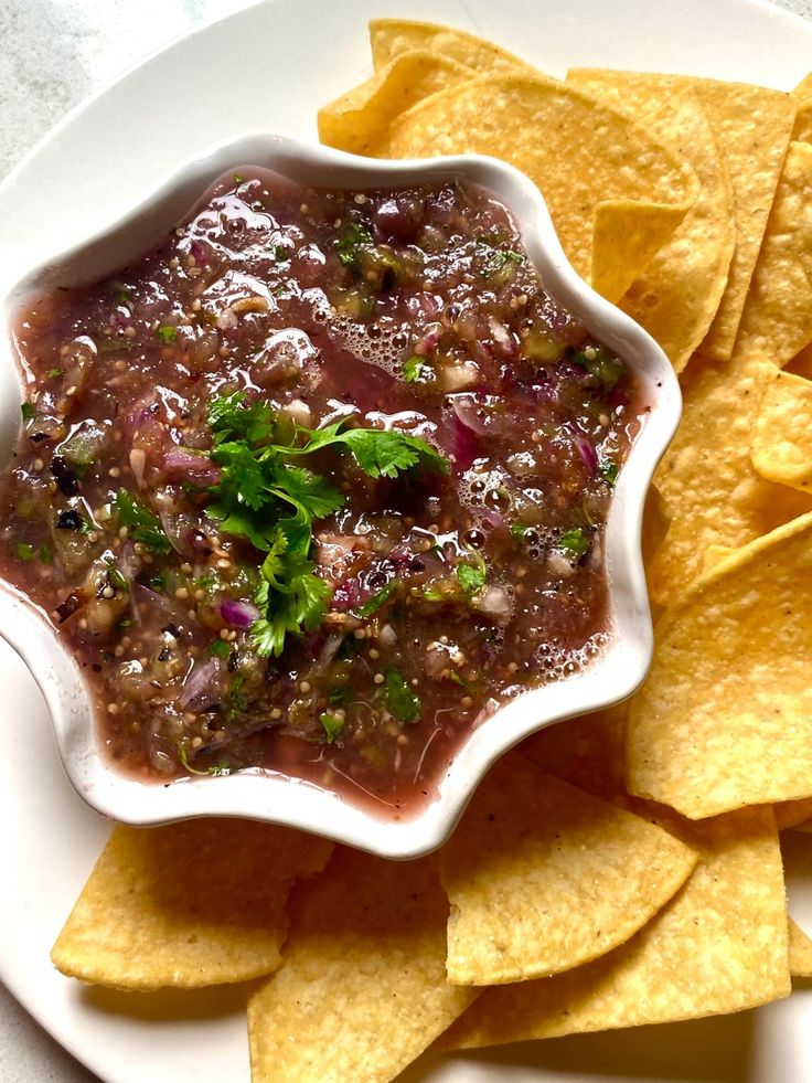 a white plate topped with chips and salsa