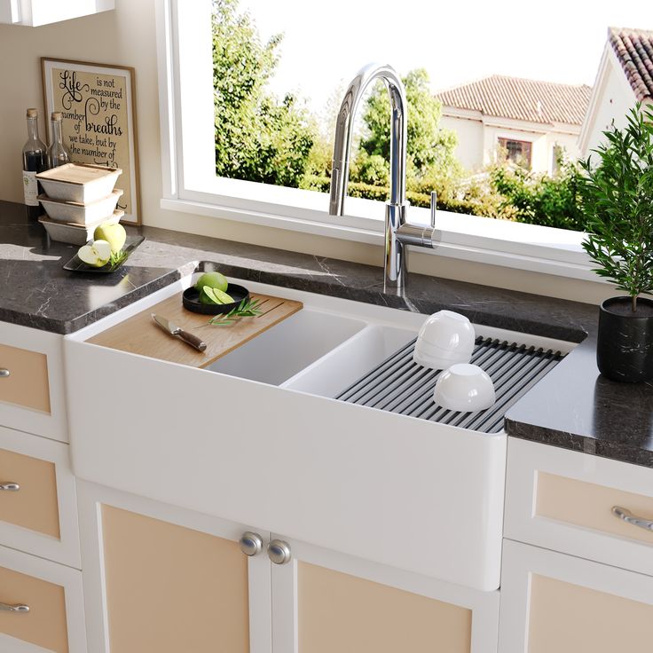 a kitchen sink sitting under a window next to a cutting board and utensils