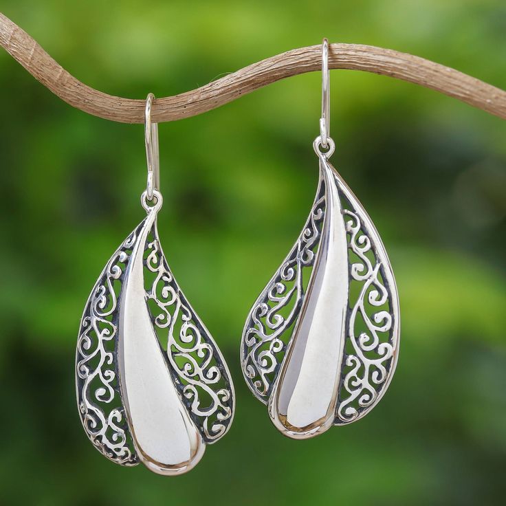 This stunning pair of sterling silver dangle earrings is from the creative mind of artisan Rattiya Chaiwong. The Thai artisan creates each earring in a beautiful leaf shape, with gorgeous openwork bordering a sleek silver center. Rattiya is inspired by the wonderful creations of the hill tribe people in her elegant design. Artisan Silver Teardrop Earrings, Artisan Sterling Silver Teardrop Dangle Earrings, Artisan Drop Earrings, White Teardrop Earrings With Intricate Design, Artisan Silver Drop Earrings, Silver Drop Artisan Earrings, Artisan Teardrop Pierced Earrings, Unique Handmade Sterling Silver Teardrop Earrings, Traditional Handmade Sterling Silver Teardrop Earrings