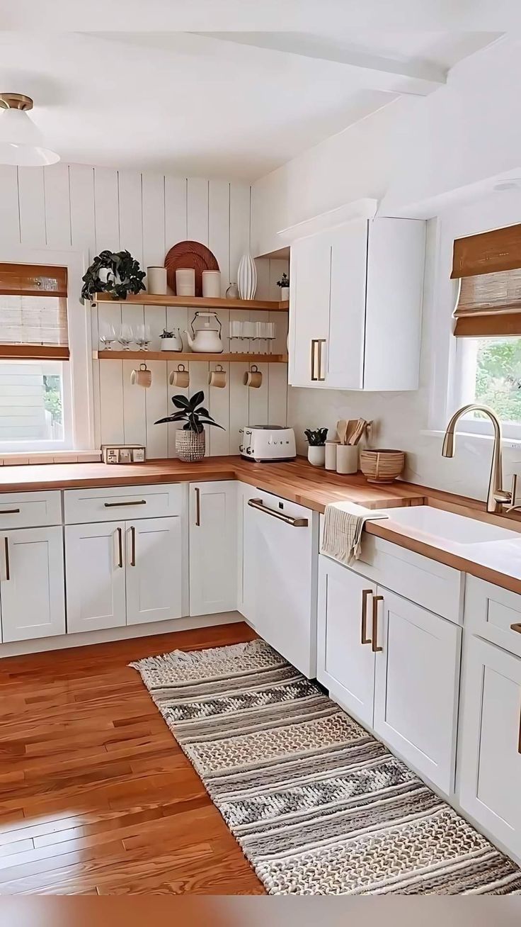 the kitchen is clean and ready for us to use it's counters are white with brown trim