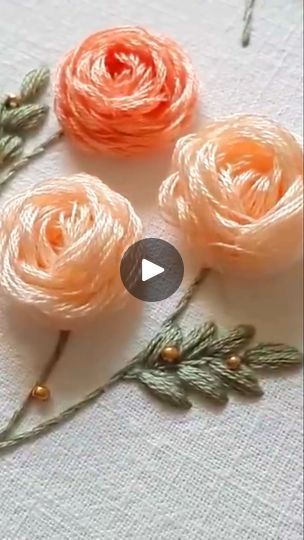 three orange flowers sitting on top of a table