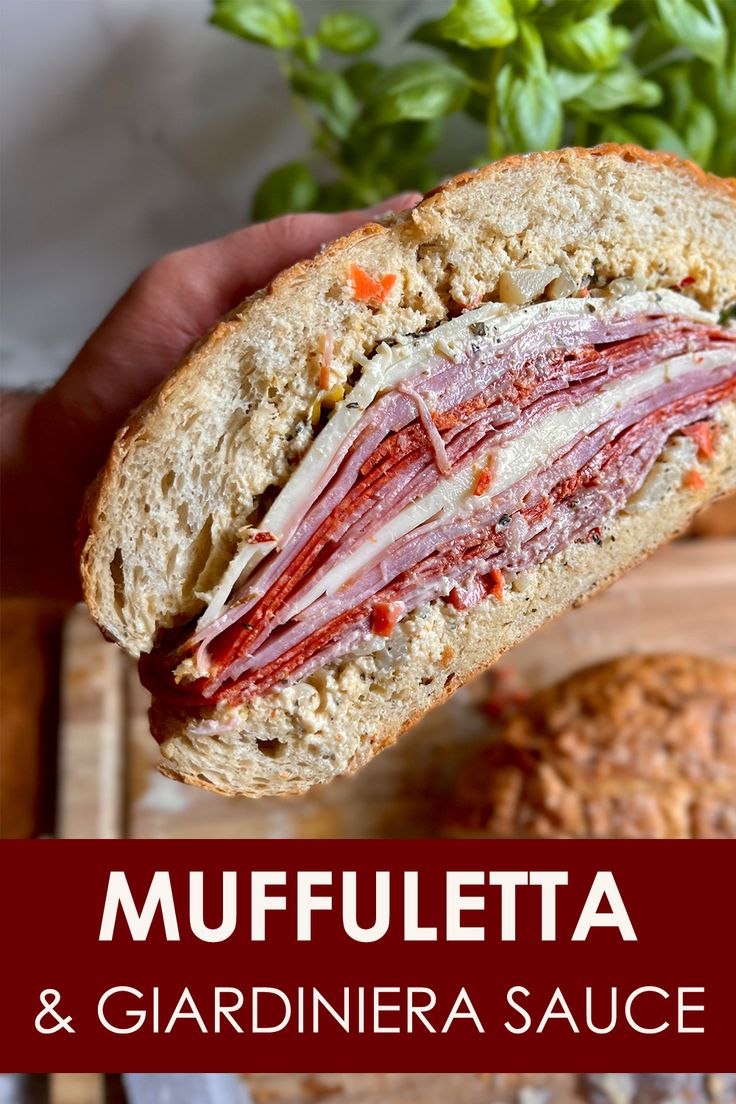 A cut half of a Muffuletta with Giardiniera sauce held toward the camera Recipes Using Giardiniera, Giardiniera Recipe Dishes, Giardiniera Sandwich, Muffaletta Recipe, Giardiniera Recipe, Italian Sandwich Recipes, Muffaletta Sandwich, Louisiana Cuisine, Truffle Sauce