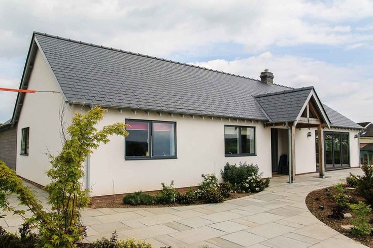 a small white house with a black roof