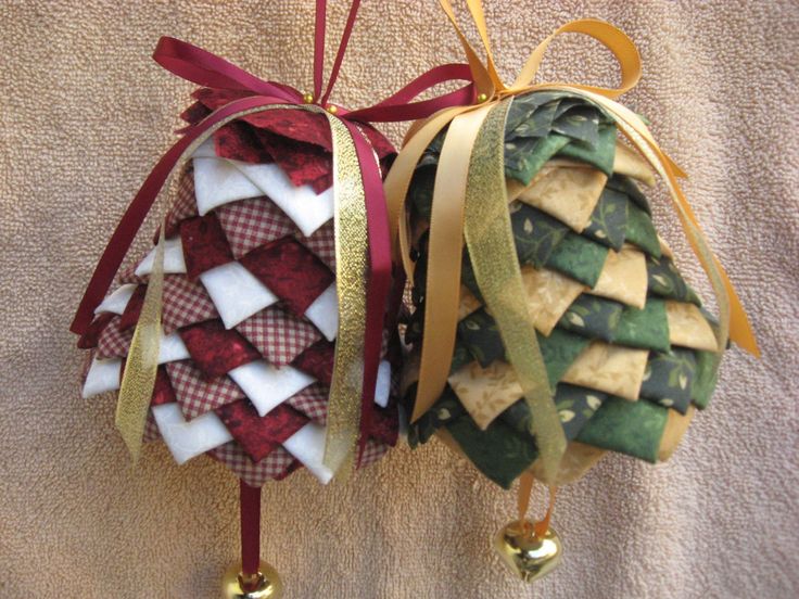 two christmas ornaments are hanging on the wall next to each other, one is decorated with ribbon