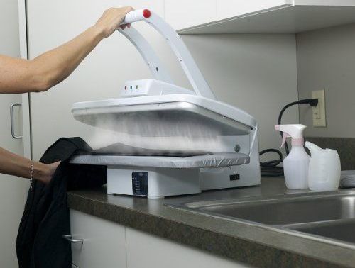 a woman is using an ironing board on the counter top in front of her kitchen sink