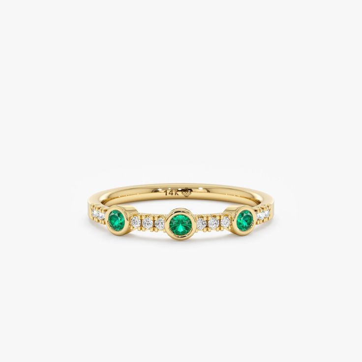 Become the timeless beauty everyone will remember. Emeralds are named after the Greek word for "green," and it is the birthstone of May, the season of spring and rebirth. This ring embodies an era of unmatched glamour and sophistication. Available in Yellow Gold, White Gold, and Rose Gold.  - Handmade - Solid Gold - Natural Diamonds and Emerald  - G Color, SI Quality Diamonds - Total Diamond Carat Weight: 0.09 ctw - Total Emerald Carat Weight: 0.20 ctw - Band Thickness: 1.5 mm - Ring Width: 2.8 Classic Green Diamond Stackable Ring, Classic Green Stackable Diamond Ring, Classic Green Stackable Rings For Formal Occasions, Formal Green Stackable Rings, Green Three-stone Birthstone Ring In 14k Gold, Green Three Stone Birthstone Ring In 14k Gold, Heirloom Green Diamond Ring With Bezel Setting, Classic Green Stackable Rings With Prong Setting, Diamond Stackable Rings For May Birthstone