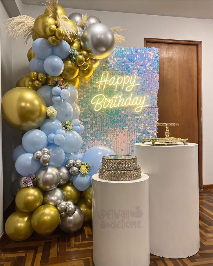 a birthday cake and balloons are on display