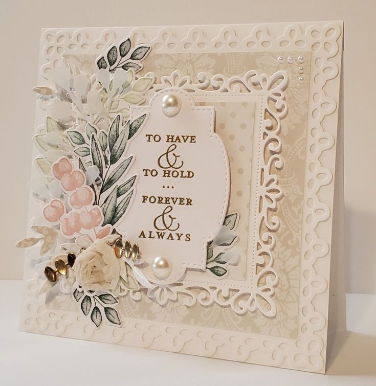 a white card with flowers and pearls on the edge that says, to have and to hold