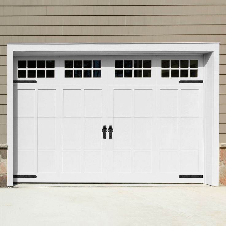 a white garage door with two windows on the side