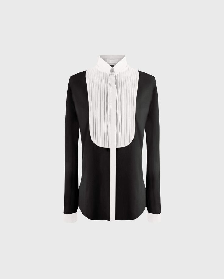 The SAPHIRA is a two-tone long sleeve polyester shirt adorned with pin tuck bib at the front. This shirt features a concealed button placket down the front, a classic collar and musketeer cuffs that allow for cufflinks. The SAPHIRA is an ANNE FONTAINE signature style, updated this season in the house's colors, black & white. Timeless Formal Blouse With Placket, Timeless Formal Collared Blouse, Timeless Formal Blouse With Collar, Formal Blouse With Concealed Placket And Spread Collar, Luxury Semi-formal Blouse With Buttons, Elegant Tailored Shirt With Buttons, Designer Semi-formal Blouse With Concealed Placket, Formal Blouse With Concealed Placket, Designer Formal Blouse With Covered Buttons