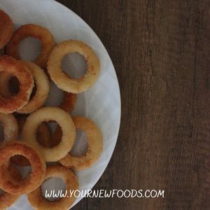 a white plate topped with donuts on top of a wooden table