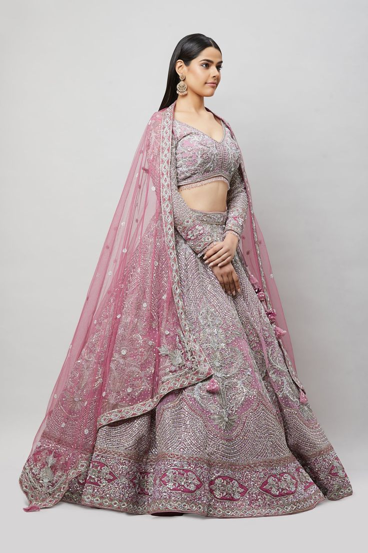 A beautiful purple lehenga with silver sequin, crystal and cutdana embroidery! Fabric: Net with satin lining All preorders will be handled by a Nazranaa Bridal Consultant who will virtually discuss measurements and minor changes according to the client's specifications Occasion: Wedding Reception WASH CARE INSTRUCTIONS - Please Dry clean only when it is applicable. Slight color variation is possible due to digital photography. Jewelry not included Purple Lehenga For Reception On Eid, Purple Lehenga For Reception During Eid, Purple Choli With Intricate Embroidery For Eid, Purple Embroidered Choli For Eid, Eid Purple Choli With Intricate Embroidery, Embellished Purple Anarkali Set For Reception, Purple Anarkali Set With Mirror Work For Wedding, Purple Mirror Work Choli For Reception, Purple Choli With Mirror Work For Reception