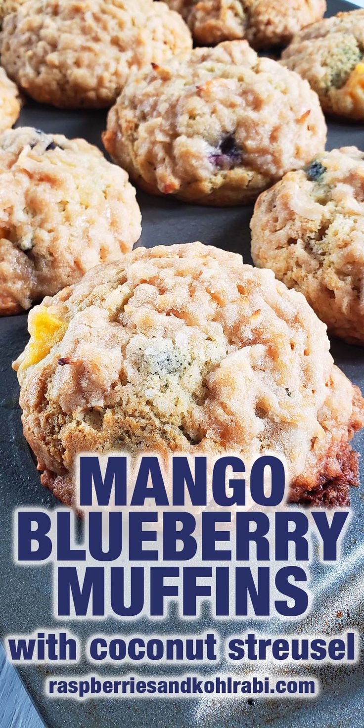 mango blueberry muffins with coconut streusel are on a baking sheet