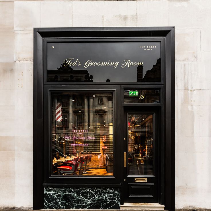 a store front with the words ted's grooming room written in gold on it