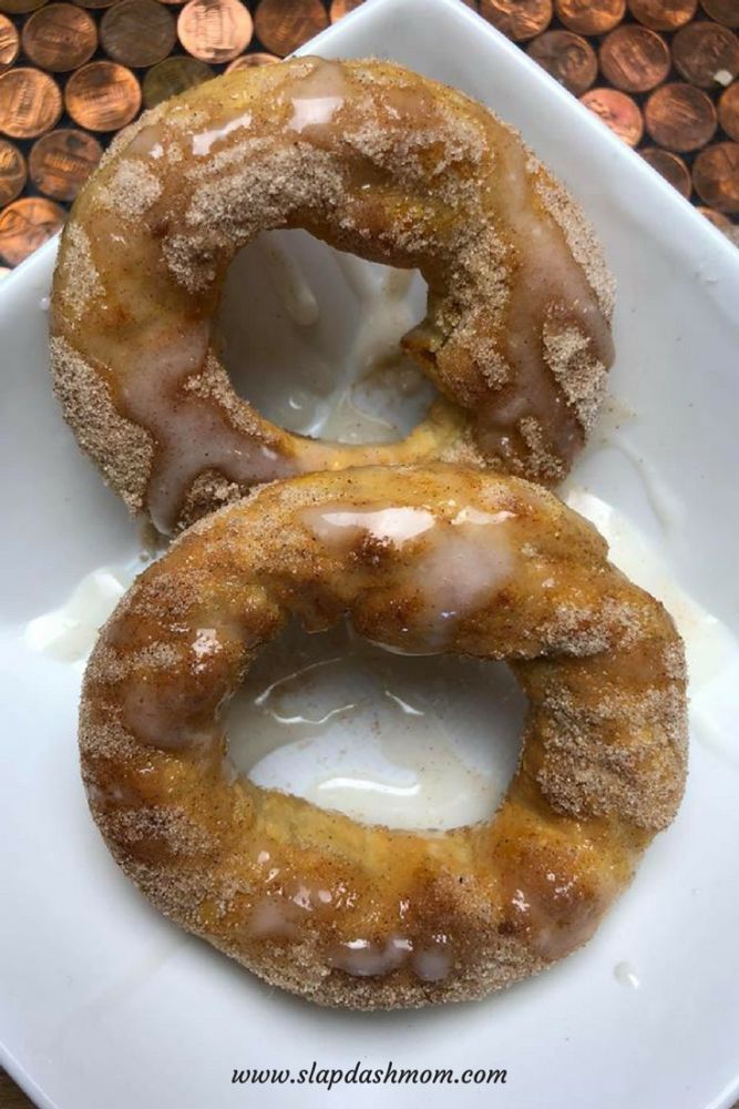 two glazed donuts sitting on top of a white plate