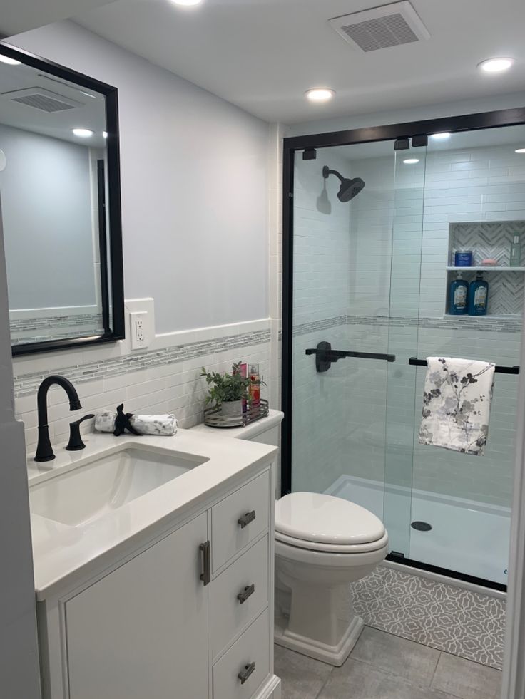 a bathroom with a sink, toilet and shower