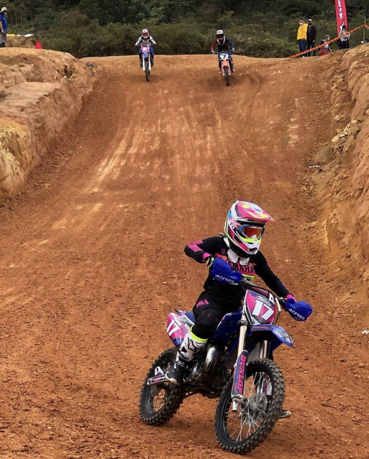 a person riding a dirt bike on a dirt track