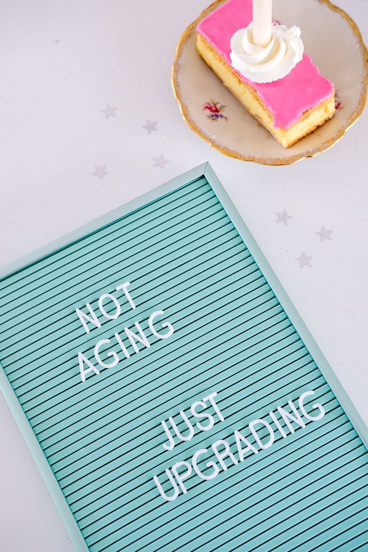 a piece of cake sitting on top of a table next to a plate with a candle