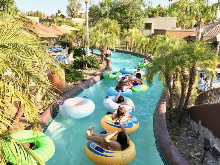 people on inflatable rafts ride down the water slide