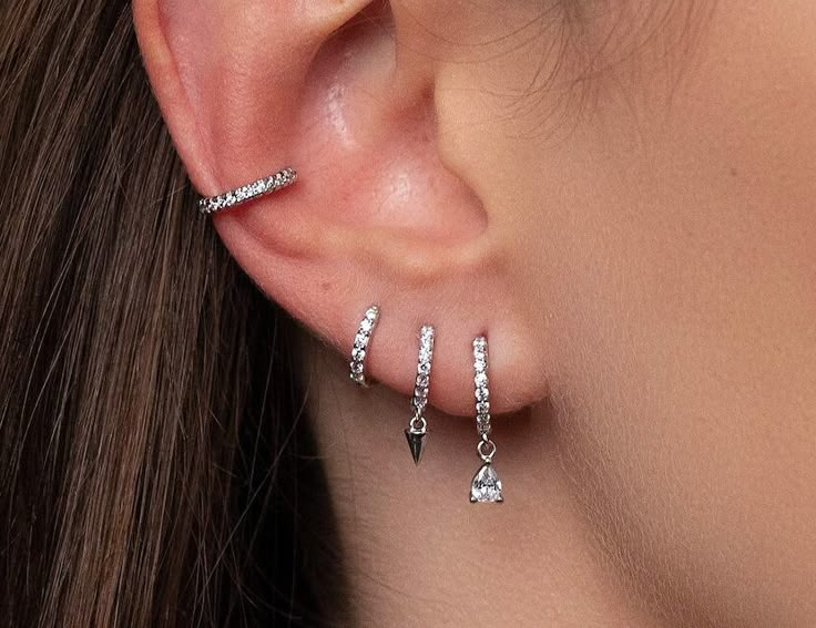 ✨Our Silver Pierced Earring Set is stylish, minimal Style. This Stacking Earring Set is perfect for every day but can also complement a party outfit. This ear stack is a great gift option. Mix and match, you will never get bored of it! :) ✨Product specifications:  * Material: Sterling Silver with Zircon stone.  * Hoops Diameter (inner): 7mm.  * Hoops width: 2mm. ✨✨FREE PERSONALISED GIFT POUCH WITH EVERY ORDER Select a gift pouch colour (lilac or cream - refer to the last photo for guidance) and make it your own by adding up to 10 letters or numbers as a personal touch. I will gladly include a gift message. ✨Care instructions: * Avoid contact with perfumes, lotions, sunscreens etc.  * Cleaning your jewellery: A wipe with a microfiber cloth will remove most dust or dirt. ( Microfiber cloth w Silver Earring Ideas, Silver Ear Stack Ideas, 3 Ear Piercings In A Row, Earring Stack Ideas 3 Holes, Stacked Earrings Silver, Earings Aesthetics Silver, Styled Ear Piercings Silver, Sterling Silver Earring Stack, Silver Earscapes