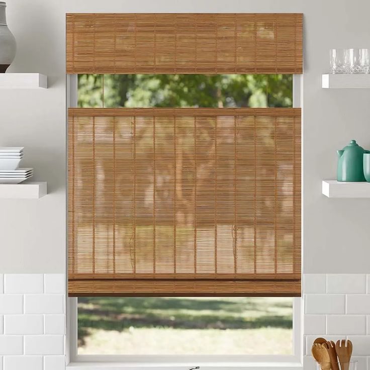 a kitchen window covered in bamboo blinds