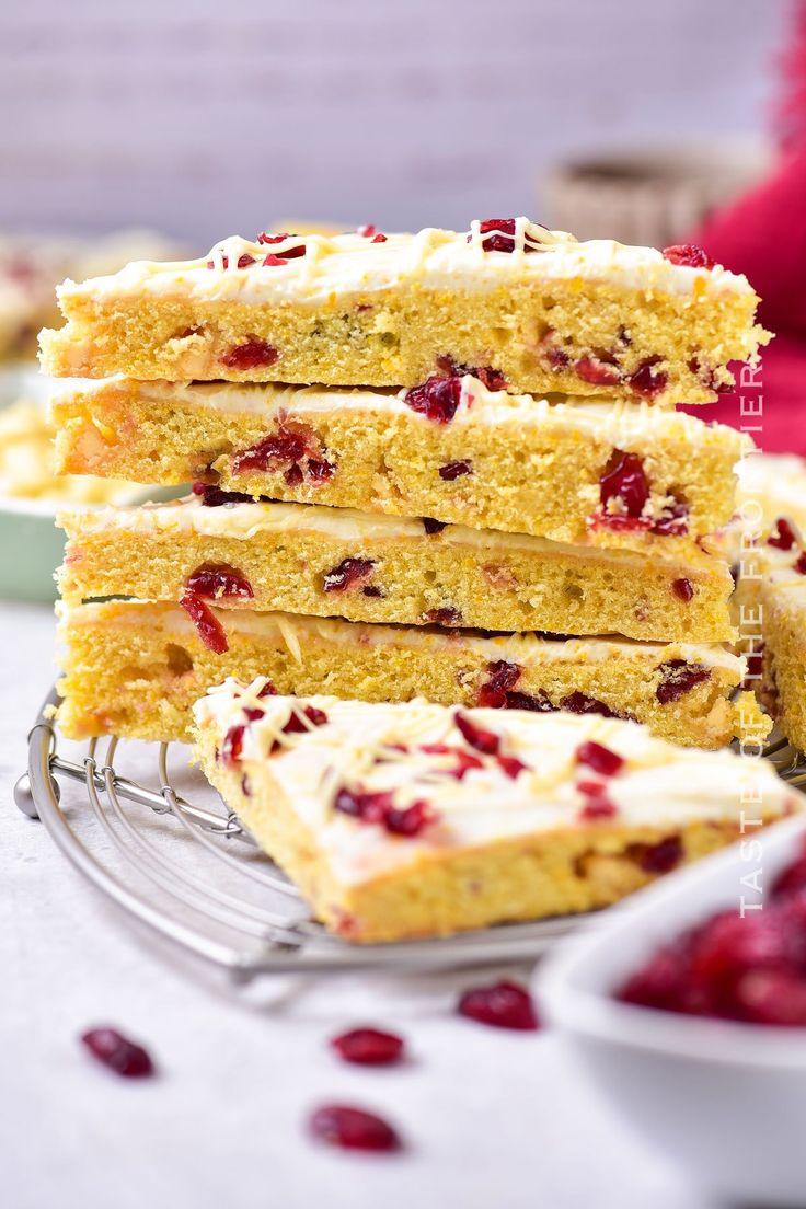 several pieces of cake with cranberry toppings are stacked on top of each other