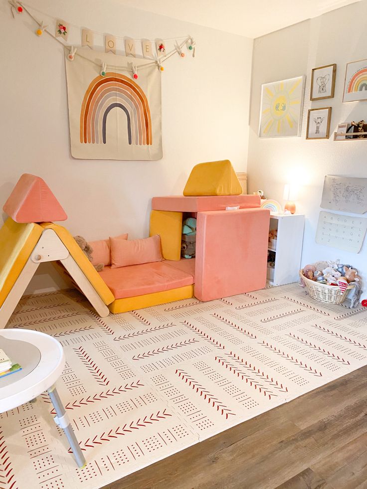 a child's play room with pink and yellow furniture in the corner, including a teepee tent