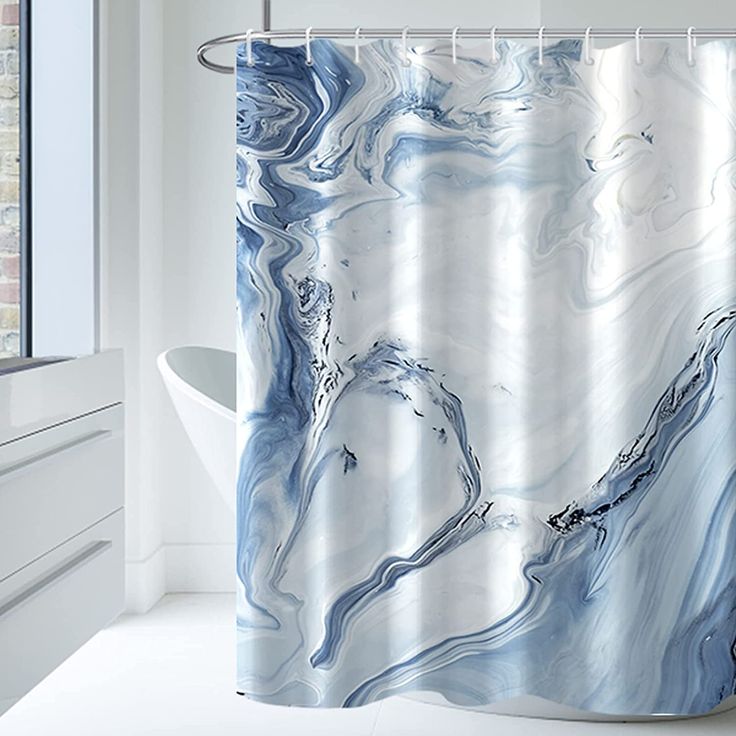 a white and blue shower curtain in a bathroom