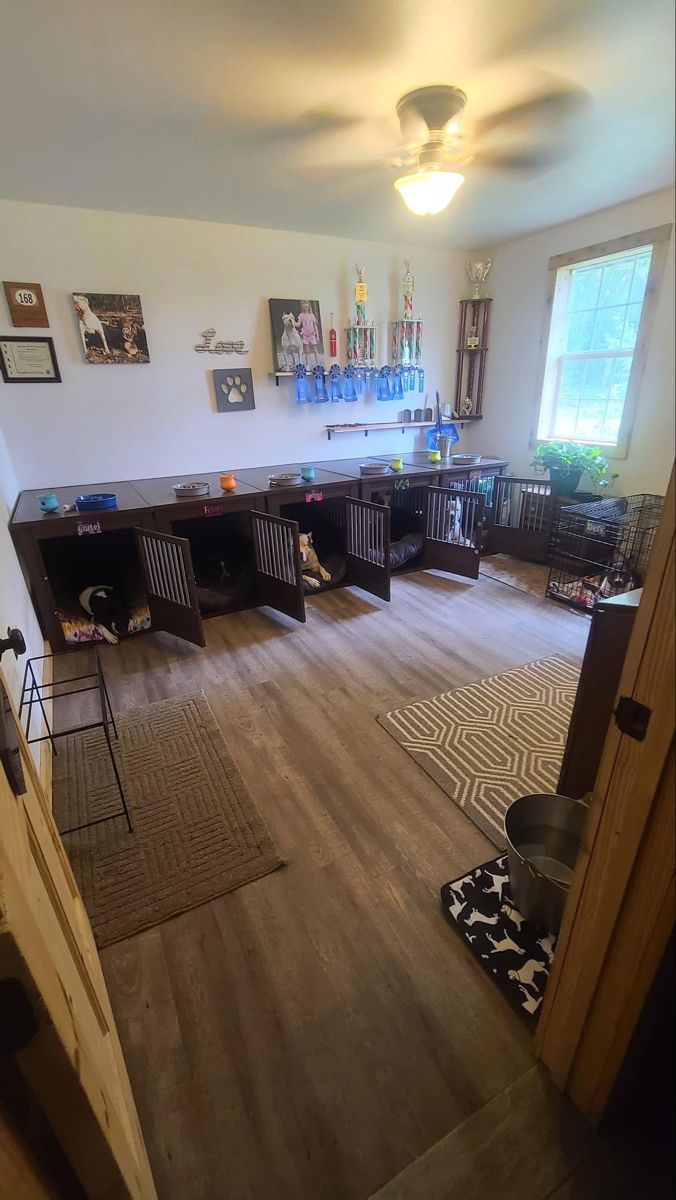 an empty room with wooden floors and lots of shelves on the wall, including dog bowls