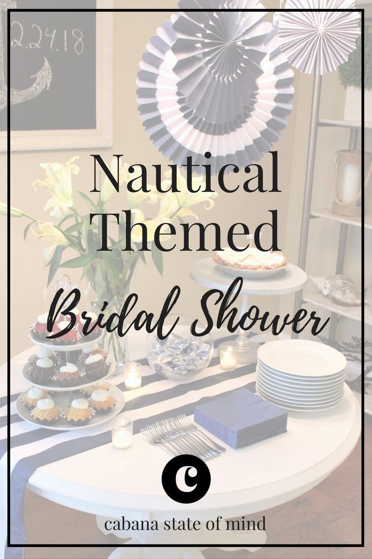 a table with plates and flowers on it that says, nautical themed bridal shower