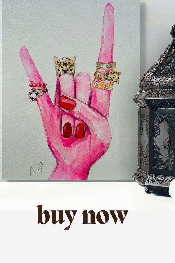 a pink hand with two rings on it and the words buy now