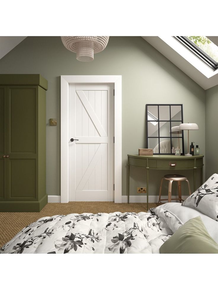 a bedroom with green walls and a white door