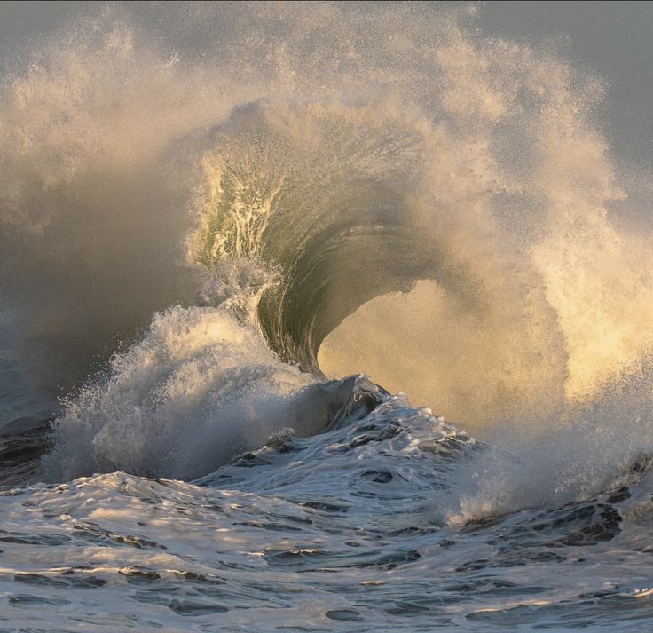 a large wave is crashing into the ocean