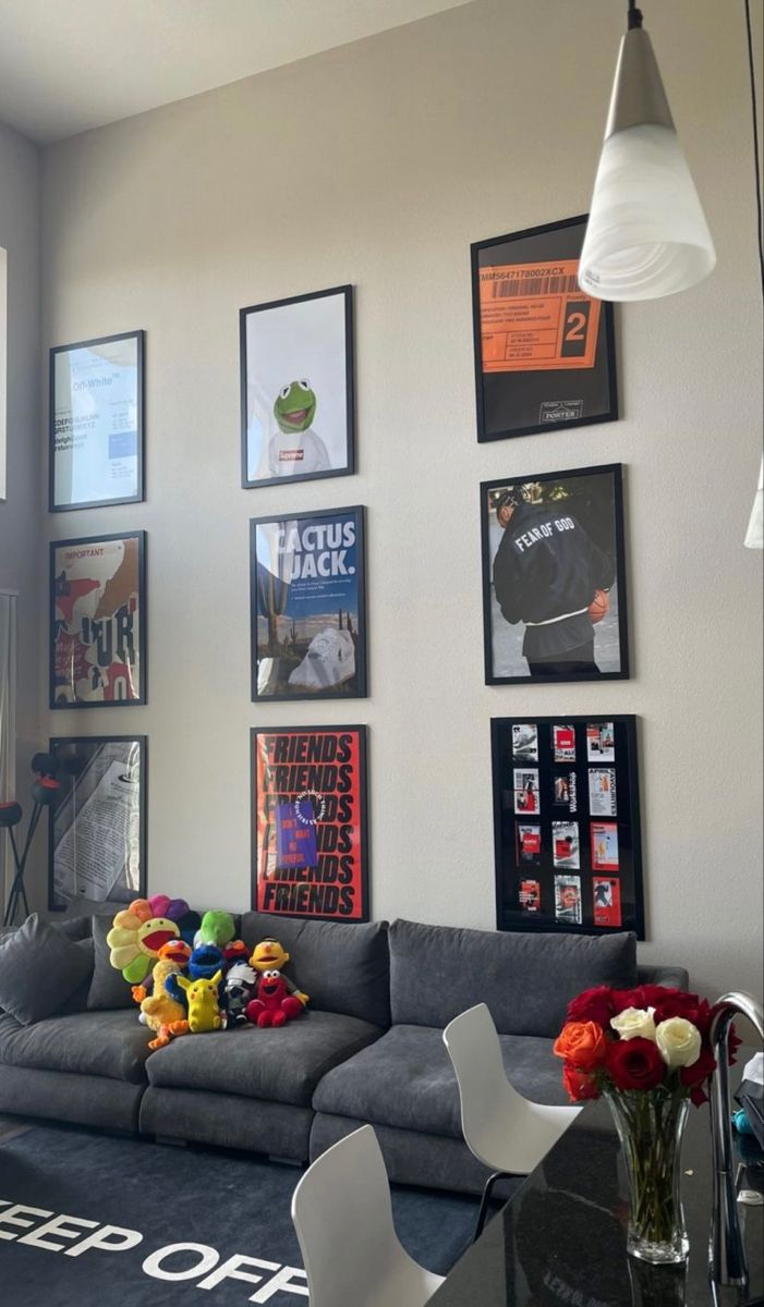 a living room filled with furniture and pictures on the wall