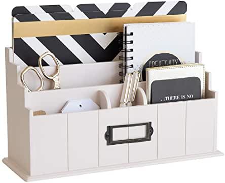 a white desk organizer with black and white stripes on the top, holding office supplies