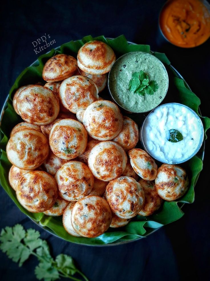 a bowl filled with food and dips on top of a table