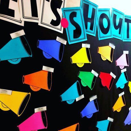 a bulletin board with the words it's showtime written on it and colorful megaphones