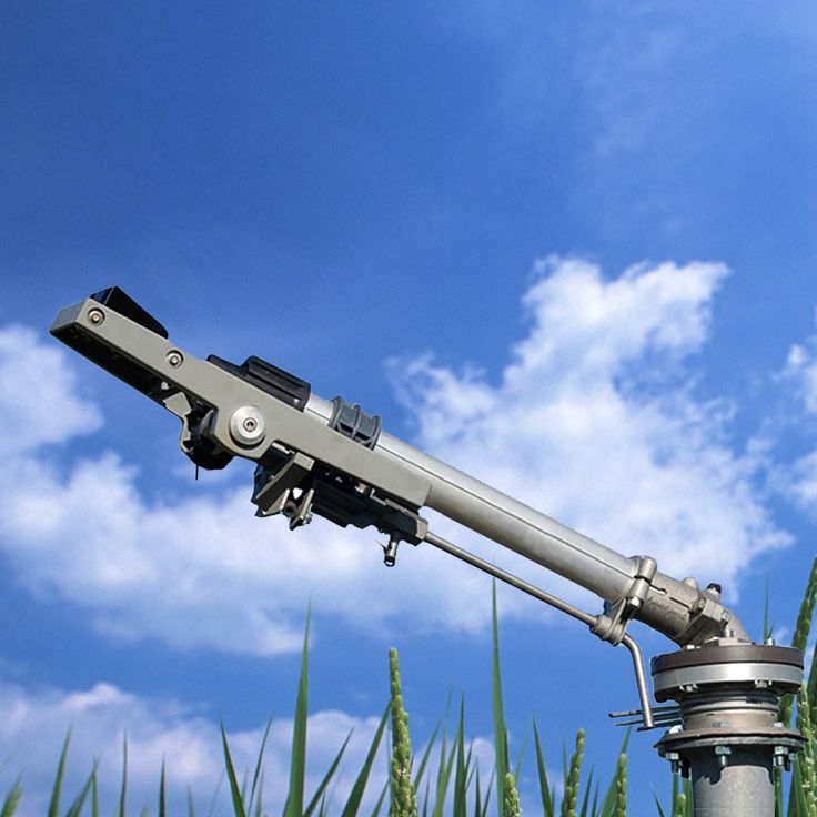 a telescope mounted on top of a metal pole in the middle of tall green grass