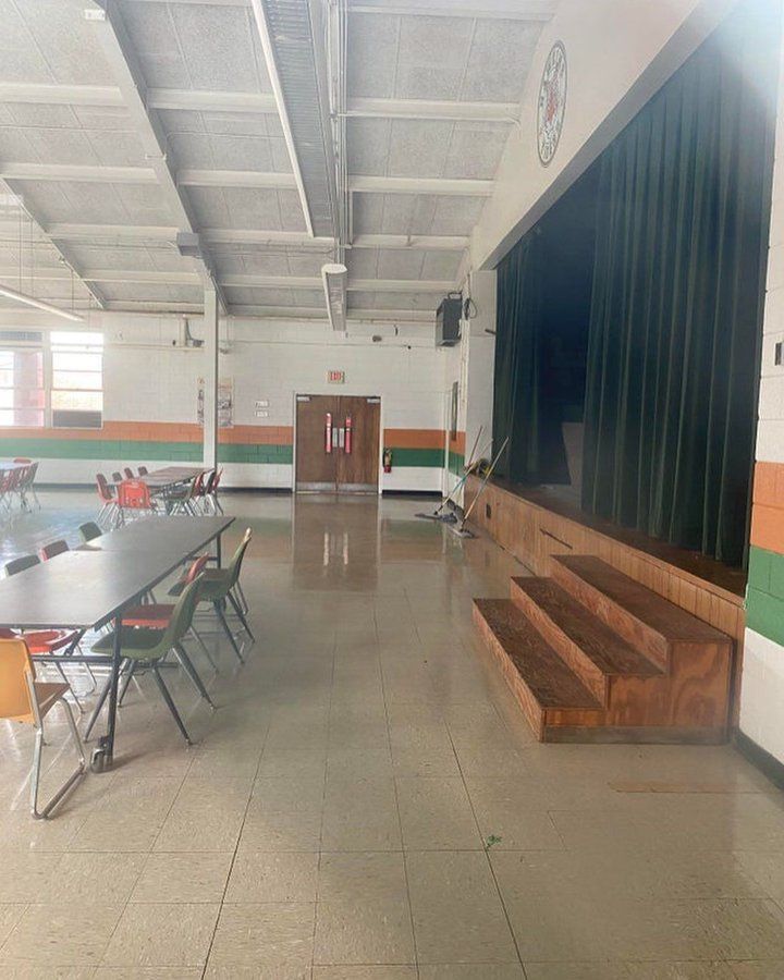 an empty school room with tables and chairs