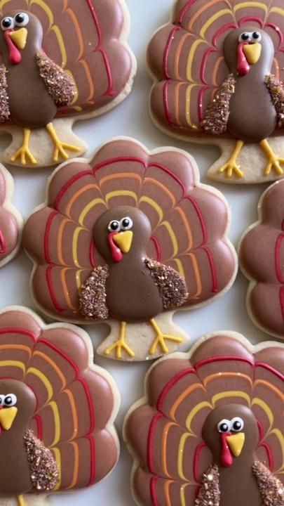 turkey cookies decorated with royal icing and sprinkles are arranged on a table