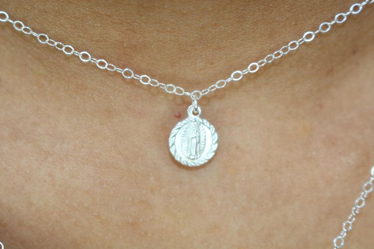 *This listing is only for one Small Virgin Mary Necklace available in Sterling Silver or 14k Gold Filled. The Virgin Mary charm is fixed onto the necklace to keep it from sliding on the chain :o) ITEM DETAILS * * 925 Sterling Silver/14k Gold Filled Virgin Mary (one sided) 8.5x10.4mm * * 925 Sterling Silver/14k Gold Filled shimmering flat cable chain * * Picture size: 15 inches   Claim your 10% Coupon by signing up to our mailing list (copy and paste link on URL) https://www.subscribepage.io/pink Silver Pendant For First Communion, Silver Pendant Jewelry For First Communion, Silver Pendant Jewelry For Baptism, Silver Dainty Jewelry For Baptism, Dainty Silver Jewelry For Baptism, Engraved Sterling Silver Jewelry For Baptism, Mary Necklace, Virgin Mary Necklace, Evil Eye Necklace Gold