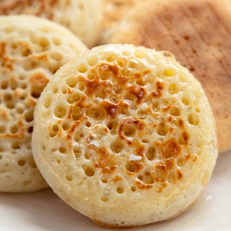 some food is on a white plate and it looks like they are made out of bread