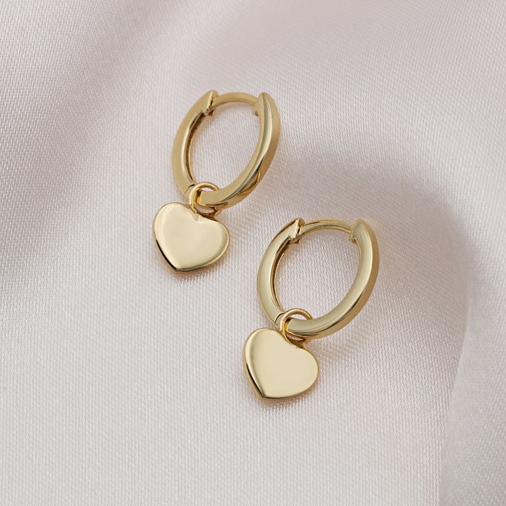 Heart of Gold. These cute little heart huggie hoop earrings will make the perfect addition to any jewellery collection. Whether there is a special someone in your life whom you wish to treat or need a little pick me up, these earrings are perfect. They are complete with a secure click-in fastening for wearing day and night. Hoop Diameter: 13mm Total Height: 20mm 925 Sterling Silver and 18ct Gold Vermeil Your item will come packaged in a lovely gift box for an added special touch. Unfortunately, Valentine's Day Minimalist Huggie Earrings, Nickel-free Huggie Earrings For Valentine's Day, Everyday Huggie Earrings For Valentine's Day, Cute Gold Heart Earrings For Mother's Day, Dainty Tarnish-resistant Huggie Heart Earrings, Nickel-free Huggie Earrings For Anniversary, Minimalist Huggie Earrings For Valentine's Day, Gold Heart Huggie Earrings Gift, Gold Double Heart Huggie Earrings Gift