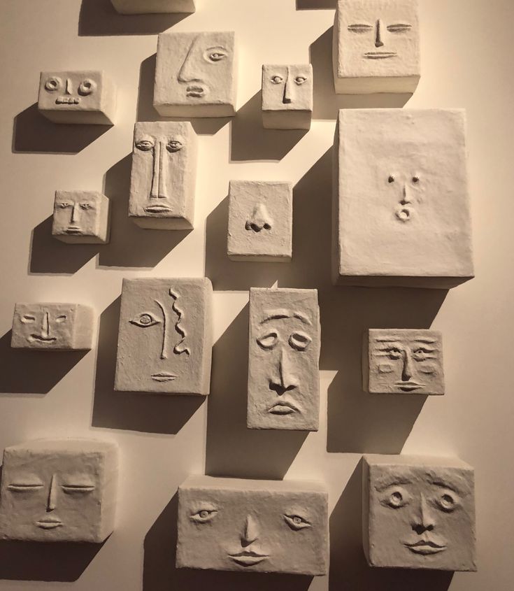 many white blocks with faces on them are arranged in the shape of squares and rectangles