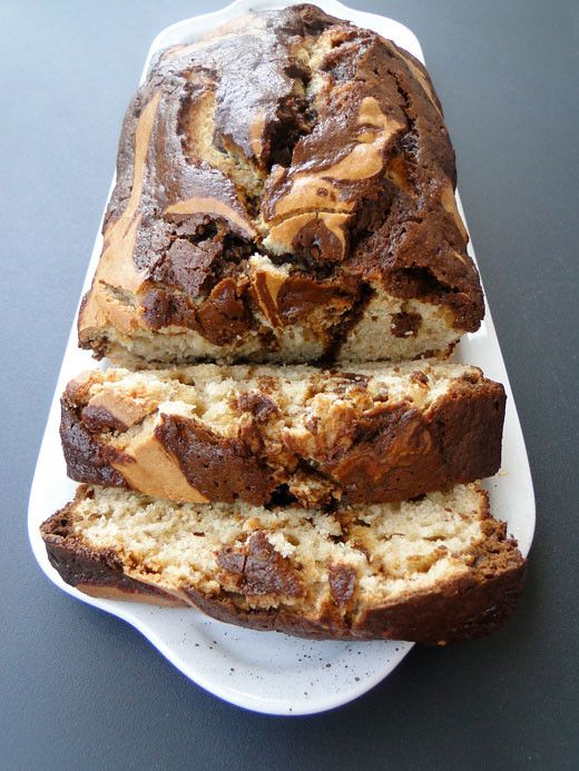 sliced loaf of banana bread on a white plate