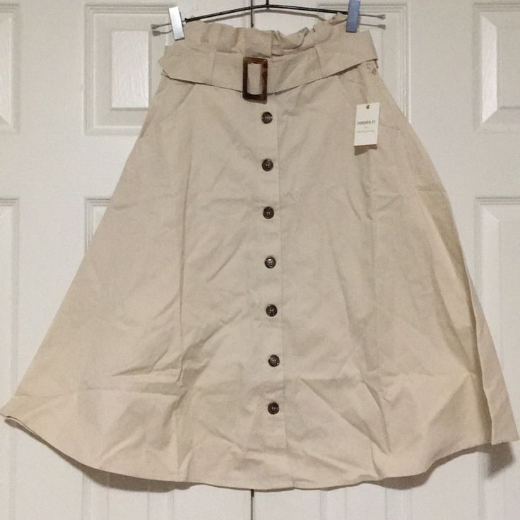 Brand New With Tags Knee Length Skirt In Cream Color With A Buckle In The Front And Button Up Design. Perfect For So Many Occasions! Can Be Paired With Long Sleeves Or Short Sleeves Or Even Sleeveless Top! Wear It With Sneakers Or Heels! Spring Button-up Lined Skirt, Beige Midi Skirt With Button Closure, Beige Button Closure Midi Skirt, High-waist Beige Skirt With Button Closure, High Waist Beige Skirt With Button Closure, Button-up Beige Skirt For Summer, Chic Forever 21 Cotton Skirt, Spring Beige Skirt With Buttons, Spring Beige Buttoned Skirt