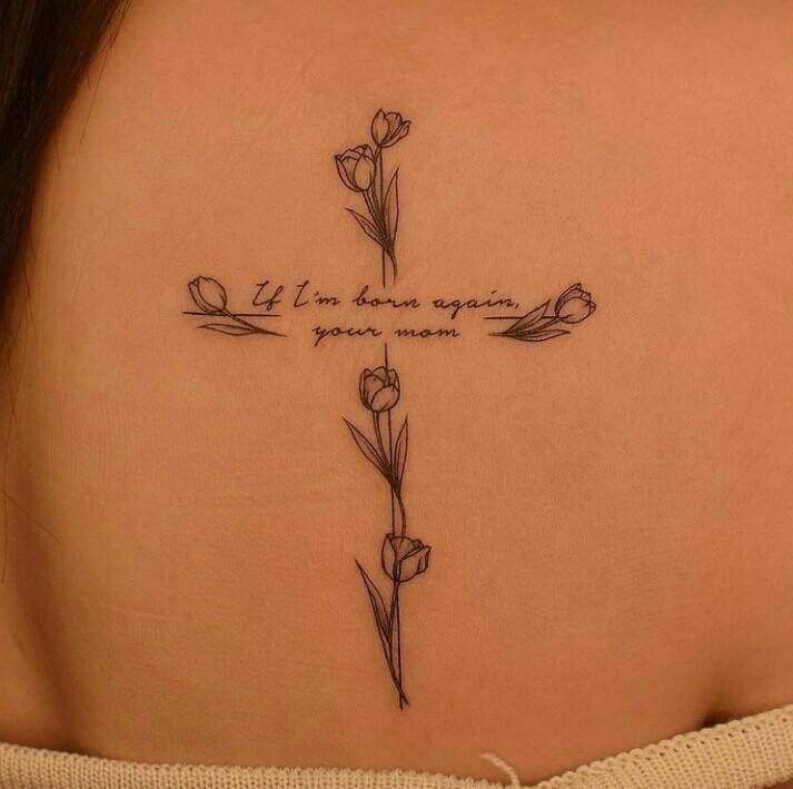 a woman's back tattoo with flowers and the words, life is always going on